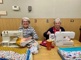 SYNC Volunteers Sewing pillowcases for charity