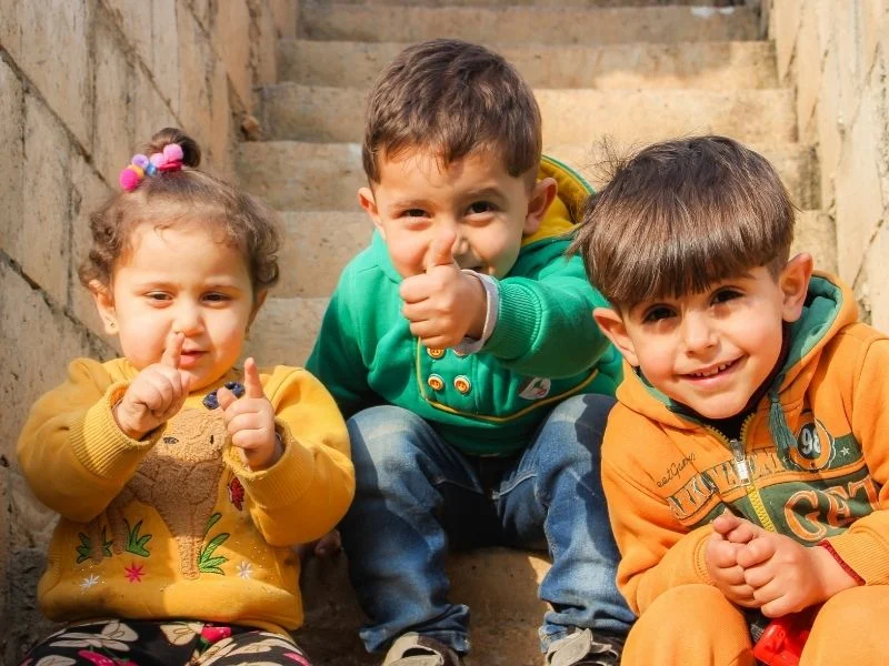 group of children sitting on stairs