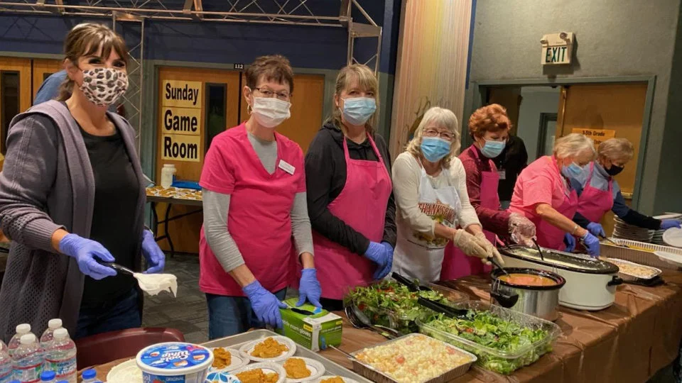 SYNC Volunteers serving dinner at a Pathfinders Meeting