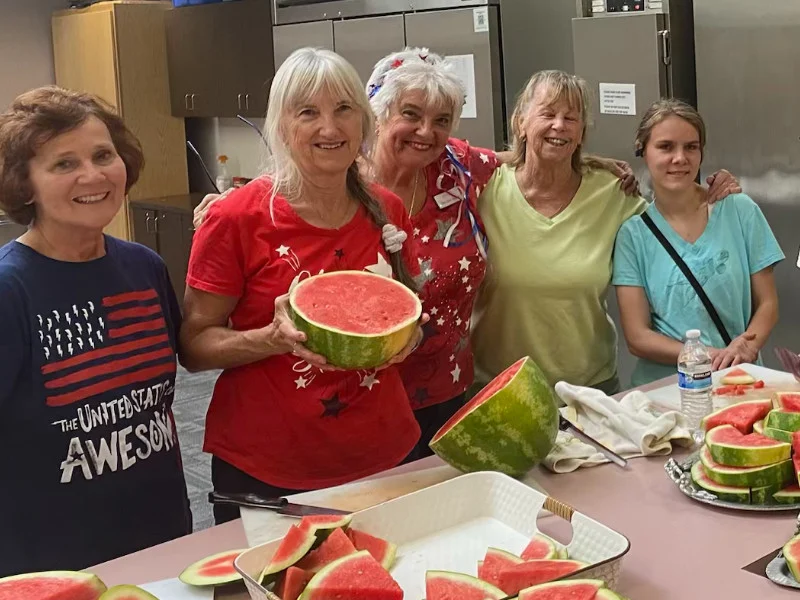 SYNC ladies cut watermelon for a Pathfinders Children's Ministry Gathering