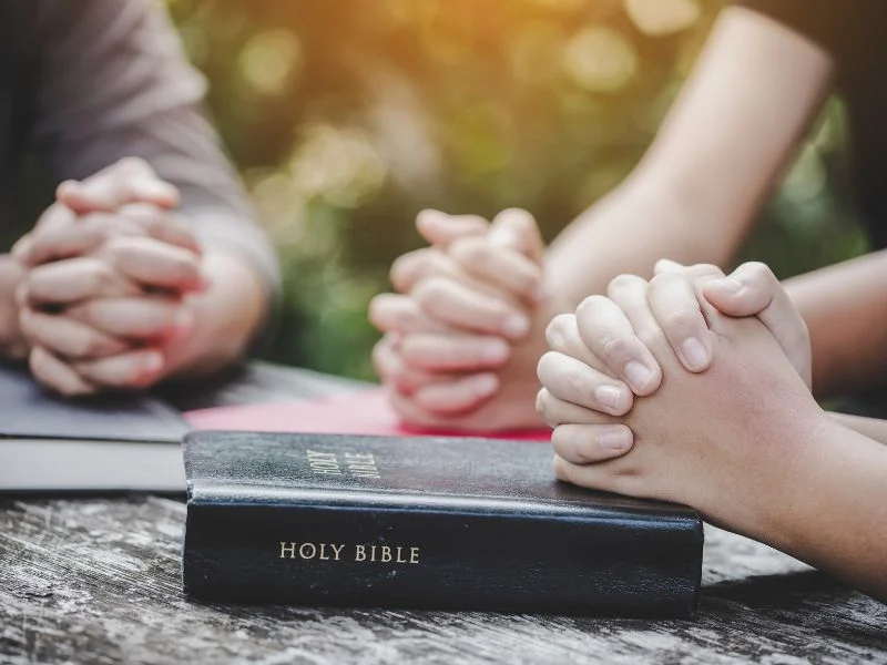Women sitting together praying